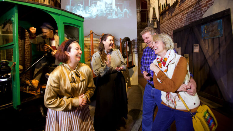Visitors and tour guides on a guided museum tour inside the American Prohibition Museum